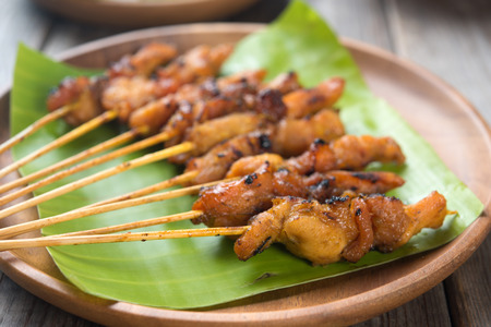 Close up Malaysian chicken satay on wooden dining table, one of famous local dishes.の写真素材