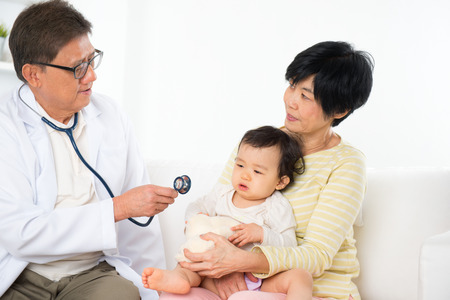 Family doctor examining baby girl. Pediatrician and patient.の写真素材
