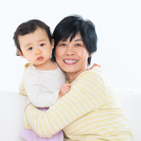 Asian family portrait, grandma and grandchild indoor living lifestyle at home.の写真素材