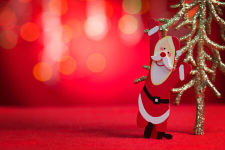 Christmas ornaments santa claus and tree with blurry glitter shiny lights at background, copy space at side.の写真素材