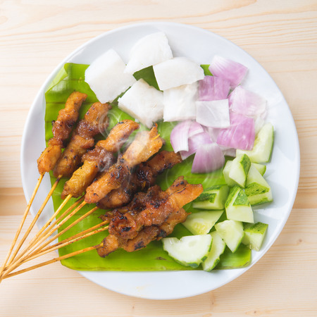 Skewered and grilled meat , chicken sate or satay, served with peanut sauce. Fresh cooked with steamed and smoke. Delicious hot and spicy Asian dish.の写真素材