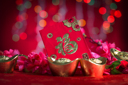Chinese new year festival decorations, ang pow or red packet and gold ingots. Chinese character means \"fortune\" or \"good luck\".の写真素材