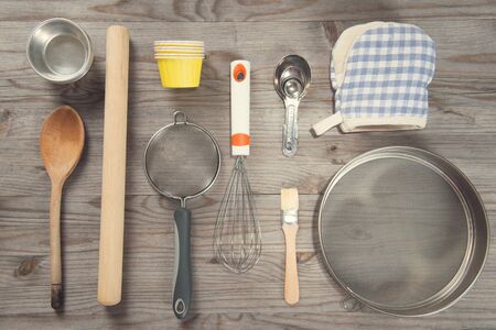 Various baking tools arrange from overhead view on wooden table in vintage tone.の写真素材