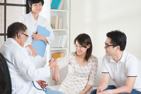 Asian couple consult doctor. Woman health concept.の写真素材