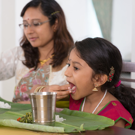 Indian family dining at home. Candid photo of India people eating rice with hands.の写真素材