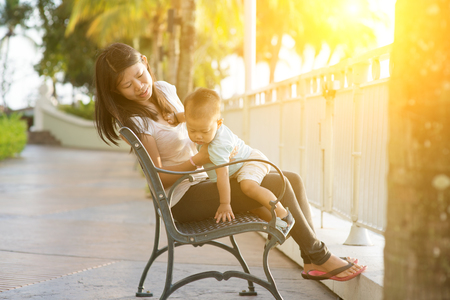 Mother and son having fun at outdoor in sunset during vacation.の写真素材