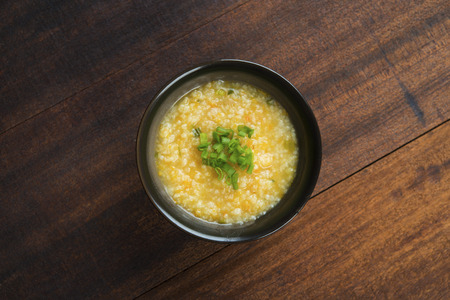 Top view porridge bowl on wooden table background.