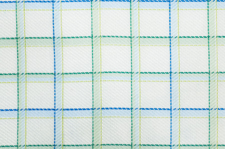Close up seamless checked green and yellow fabric pattern texture background.