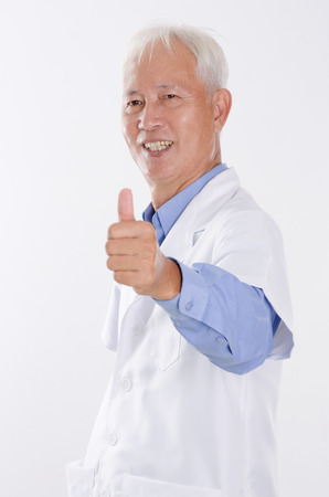 Portrait of confident Asian lab people smiling and giving thumbs up, standing isolated on white background.の写真素材
