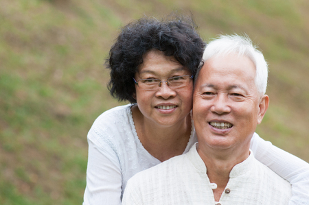 Portrait of old Asian couple relaxing at outdoor park.の写真素材