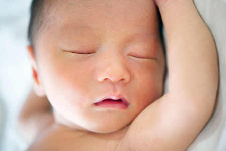 Close up cute Asian newborn baby sleeping, 7 days old.の写真素材