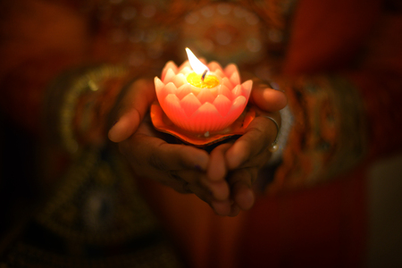 Indian female hands holding Diwali oil lamp. の写真素材