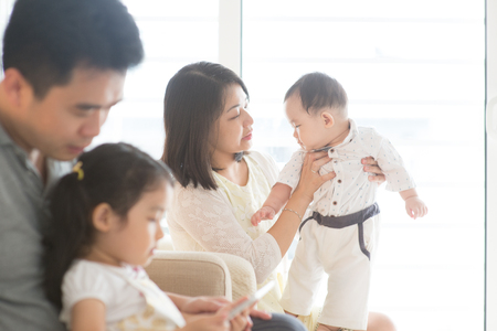 Happy Asian family at home, candid living lifestyle indoors.の写真素材