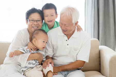 Asian elderly and children playing at home, old senior pensioner people indoor lifestyle.の写真素材