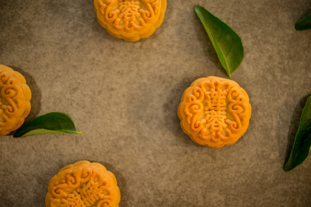 Traditional mooncakes is offered to friends or family during Mid-Autumn Festival. Flatlay table top view on dark background. The Chinese character on the moon cake represent "lotus paste" in English.の写真素材
