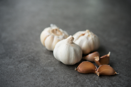 Garlic cloves and bulb with copy space on darkの写真素材