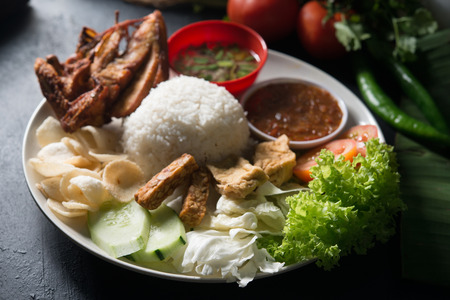 Nasi lemak kukus with fried chicken, popular traditional Malaysian local food.の写真素材