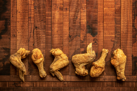 Top view flat lay original recipe fried chickens with copy space, on dark wooden background.の写真素材