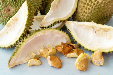 Leftover durian, shells and seeds on table.