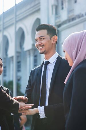 Multiracial business people stacking hands, businessman and businesswoman teamwork concept.