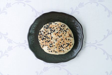 Chinese moon cake or pastry with sesame on top.