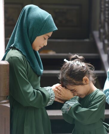 Muslim children greeting, Hari Raya Eid Al-Fitr concept.の写真素材