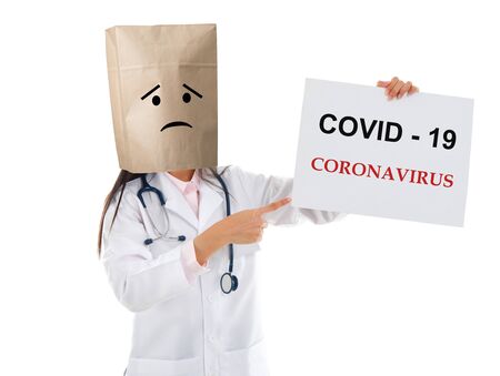 Medical staff holding a card with covid 19 on it.の写真素材