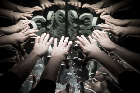 Hands Reaching for European Euro Currency Symbol on Mirror Covered In Smoke With many Reflections of Itselfの写真素材