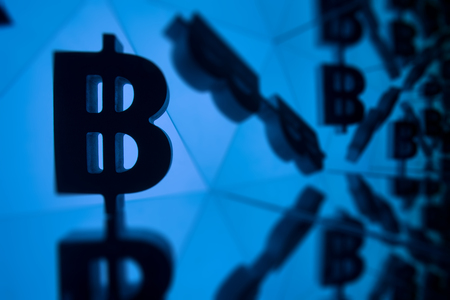 Bitcoin Currency Symbol With Many Mirroring Images of Itself on Blue Backgroundの写真素材