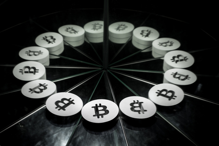 Bitcoin Crypto Currency Symbol on Mirror Covered In Smoke With many Reflections of Itselfの写真素材