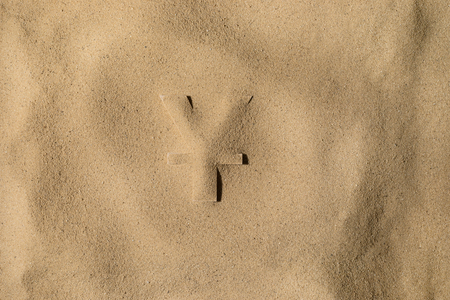 Japanese Yen or Chinese Yuan Symbol or Sign Covered with Sand in the Sun after Crisisの写真素材