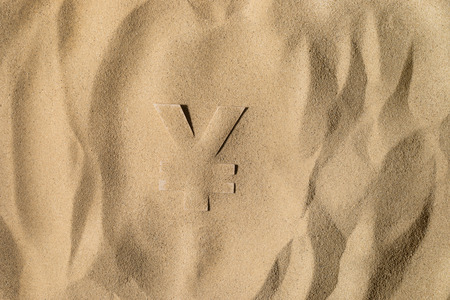 Japanese Yen or Chinese Yuan Symbol or Sign Covered with Sand in the Sun after Crisis