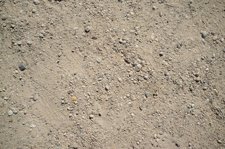 Dusty Road with Small Rocks, Dirt, Footprints, Car and Bicycle Traces Textureの写真素材