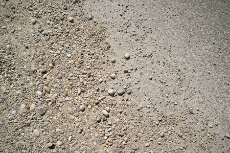 Dusty Road with Small Rocks, Dirt, Footprints, Car and Bicycle Tracesの写真素材