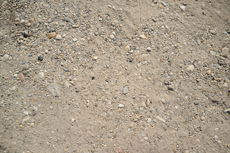 Dusty Road with Small Rocks, Dirt, Footprints, Car and Bicycle Tracesの写真素材