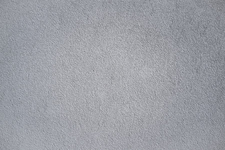 Monochromatic Grainy Texture of Plaster Wall on Bright Sunの写真素材