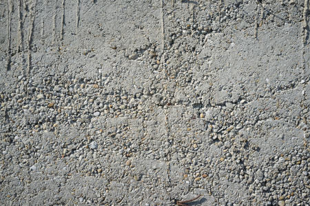 Crumbly Roughly Done Weathered Grey Concrete Wall with Pebbles Texture Detailの写真素材