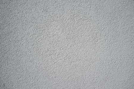 Monochromatic Grainy Texture of Plaster Wall on Bright Sunの写真素材