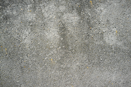Monochromatic Texture of Old Weathered Concrete Wall with Cracks and Water Stainsの写真素材