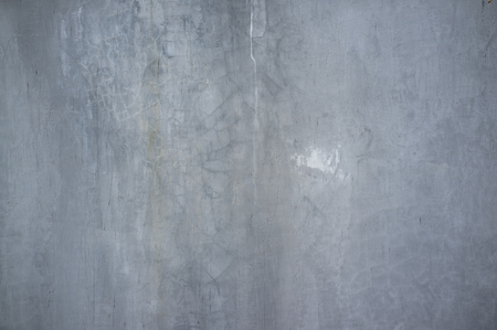 Monochromatic Texture of Old Weathered Concrete Wall with Cracks and Water Stainsの写真素材