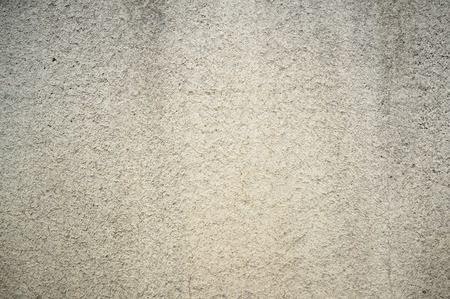 Monochromatic Texture of Old Weathered Concrete Wall with Cracks and Water Stainsの写真素材