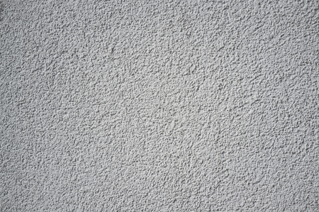 Monochromatic Grainy Texture of Plaster Wall on Bright Sunの写真素材