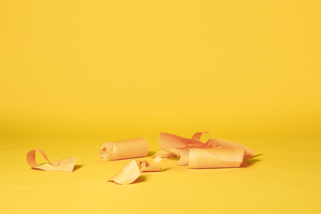 Various Stripes of Yellow Paper Left on Vibrant Yellow Seamless Backgroundの写真素材
