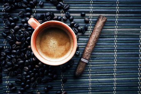 cup of coffe with coffe beans and cigarの写真素材