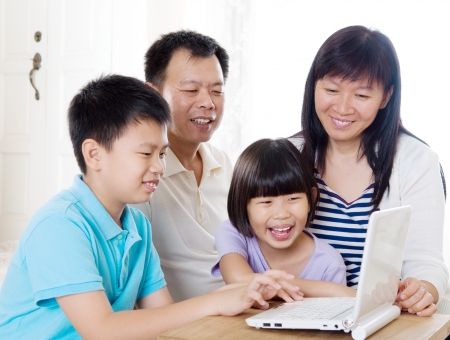 Asian family using laptopの写真素材