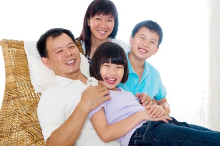 Indoor portrait of happy asian familyの写真素材