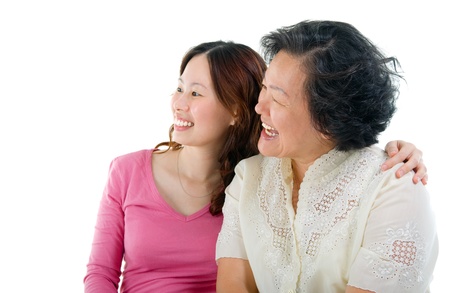 Asian senior woman and daughter looking to the side の写真素材