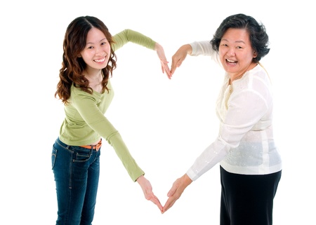 Asian senior woman and daughter making the sign of love, isolated on white background の写真素材