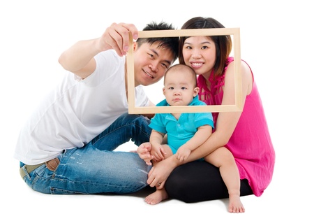 Asian family posing with wooden frameの写真素材