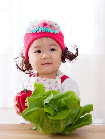 Cute asian girl with vegetablesの写真素材